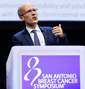 A photo of Charles Swanton, MD, PhD, FAACR, delivering his lecture at the San Antonio Breast Cancer Symposium 2023.