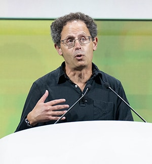 Benjamin Cravatt, PhD, speaking at a podium at the AACR Annual Meeting 2024 during the Opening Plenary. 