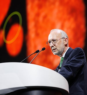Don Cleveland, PhD, FAACR, at a podium on stage during the plenary "Discovery Science in Early Cancer Biology and Interception" at the AACR Annual Meeting 2024.